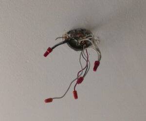 Exposed ceiling wiring from where the ceiling fan used to be