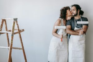 Image of couple cleaning up after painting by Annette Lucina