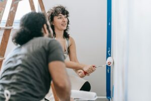 Image of a couple painting a wall by Annette Lucina