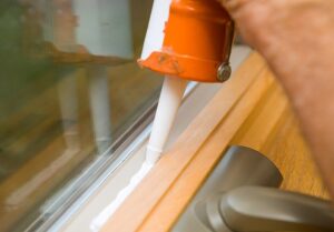 Image of caulk being applied to window