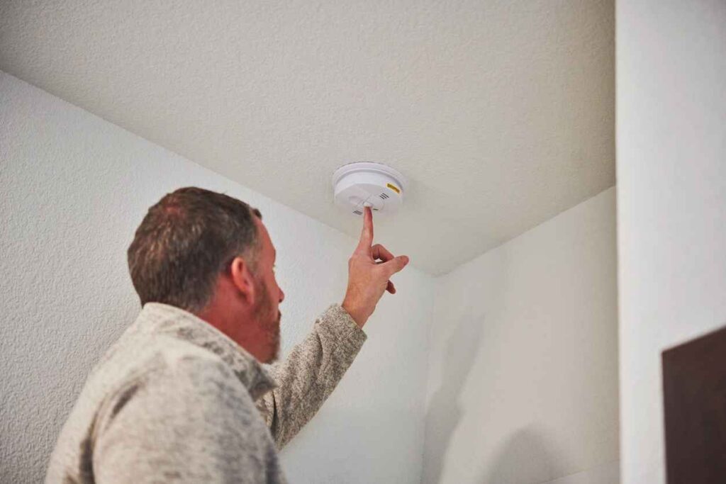 A Man installing a Carbon Monoxide Detector